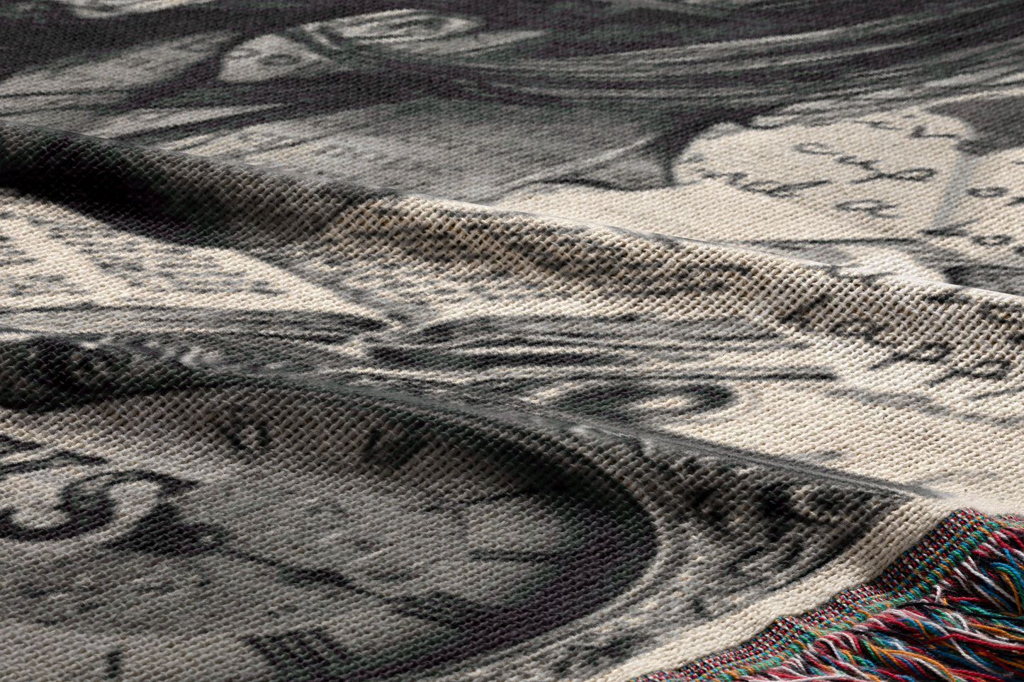 The image is a close-up of a fabric with a printed design, featuring a clock and other abstract shapes. The fabric appears to be a blanket or textile with a textured surface.