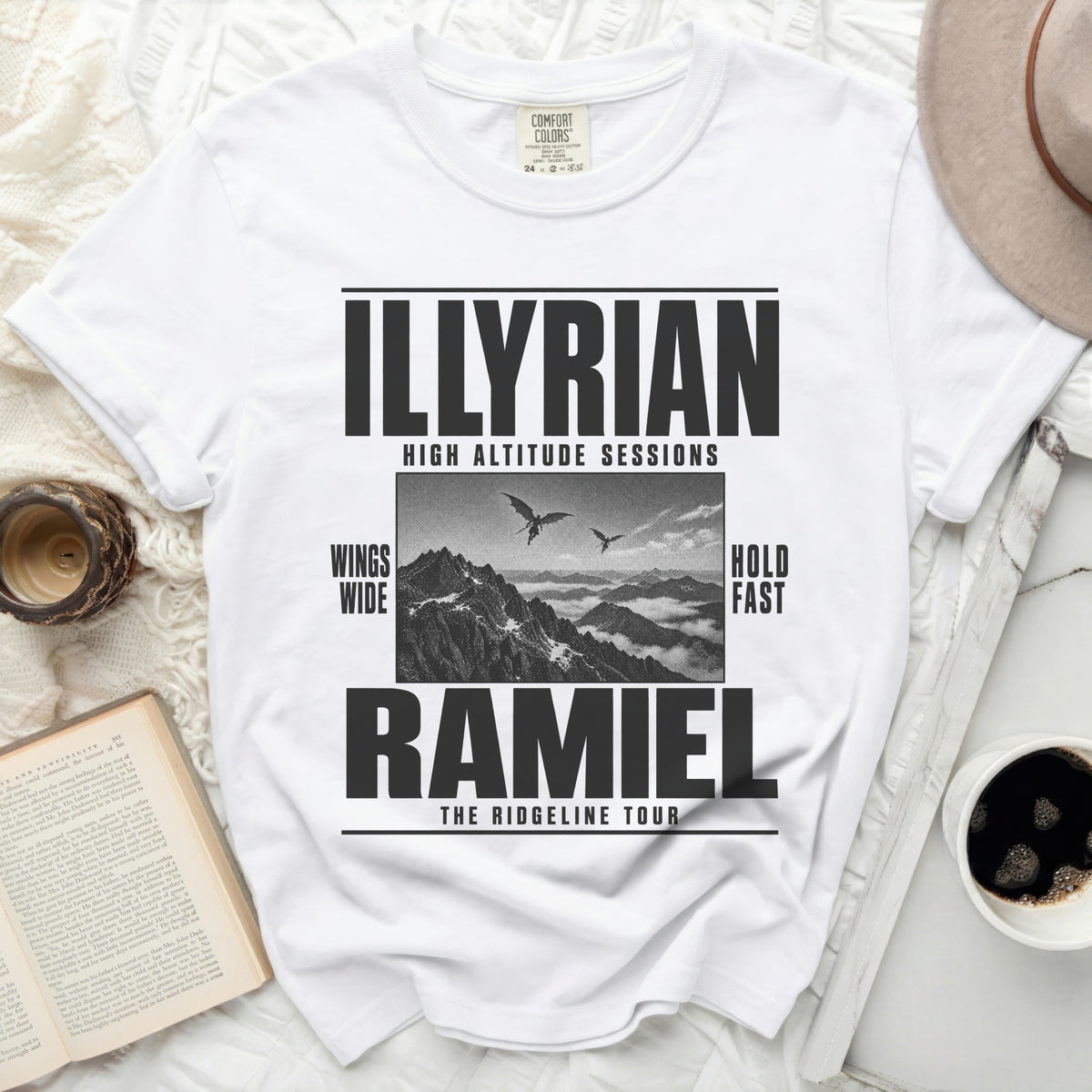White t-shirt with "ILLYRIAN HIGH ALTITUDE SESSIONS RAMIEL THE RIDGELINE TOUR" text.