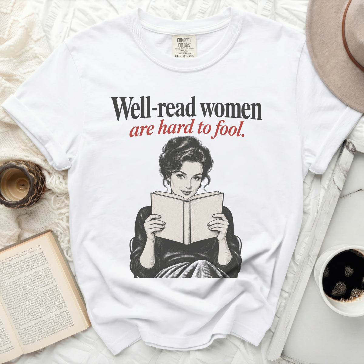White t-shirt with "Well-read women are hard to fool" and vintage woman reading.