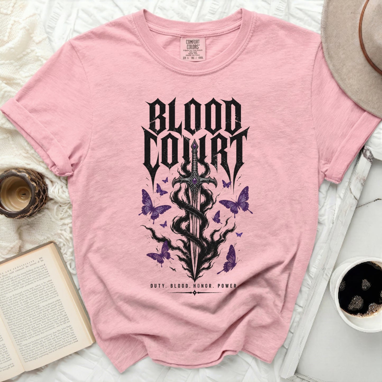 Pink t-shirt with "Blood Court" text, sword, and butterflies graphic.