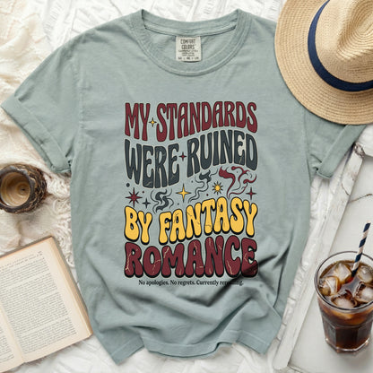 T-shirt with "My Standards Were Ruined By Fantasy Romance" text.