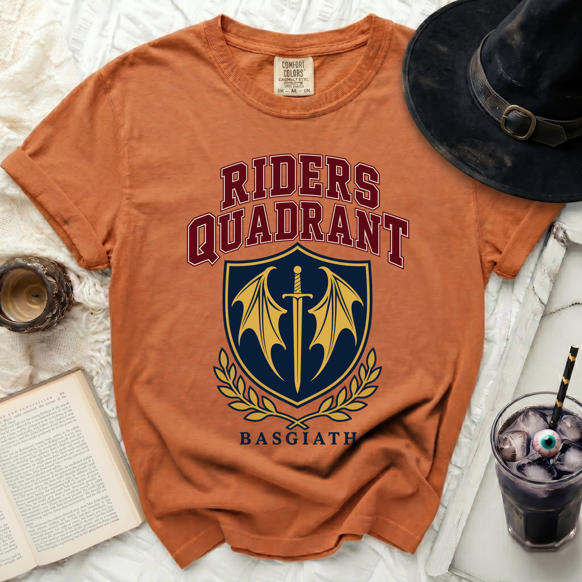 Orange t-shirt with "RIDERS QUADRANT BASGIATH" text and shield graphic.