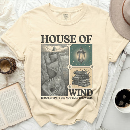 T-shirt with "House of Wind" design featuring stairs, lantern, and books.