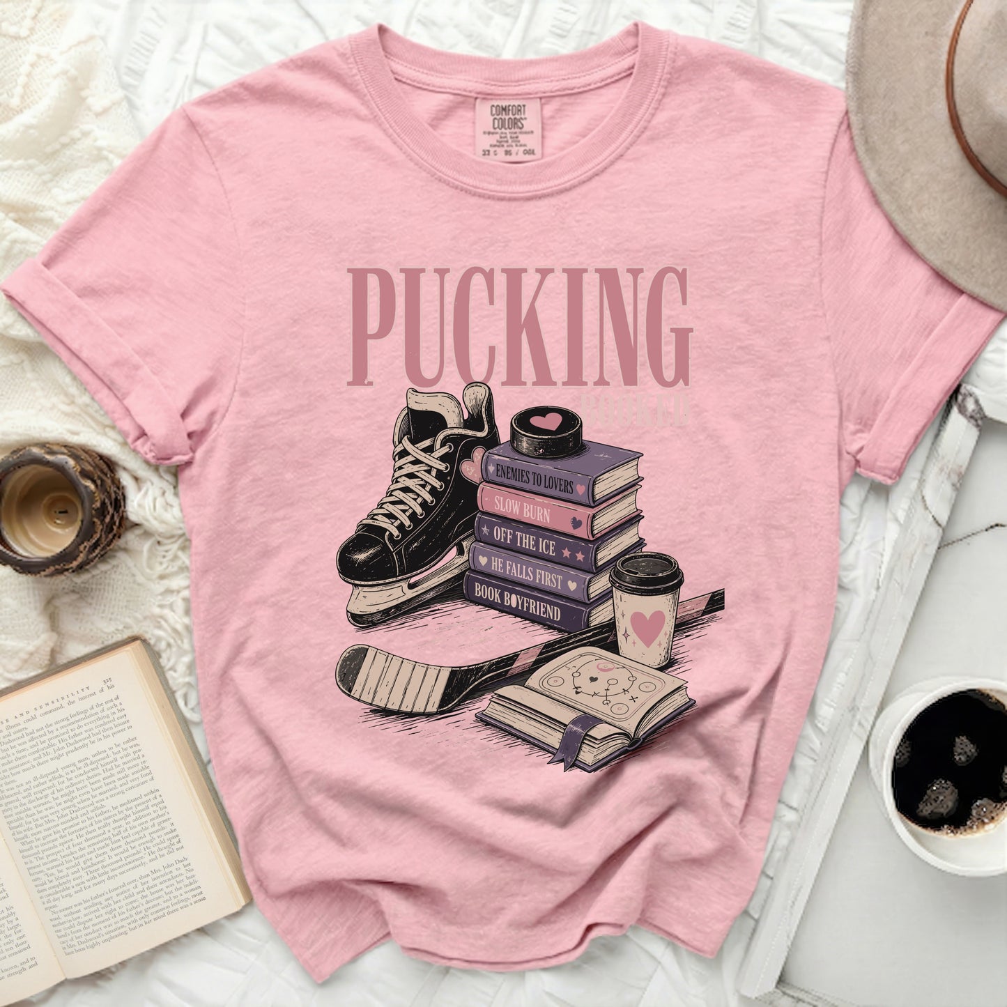 Pink t-shirt with "Pucking" and romance book titles related to hockey.