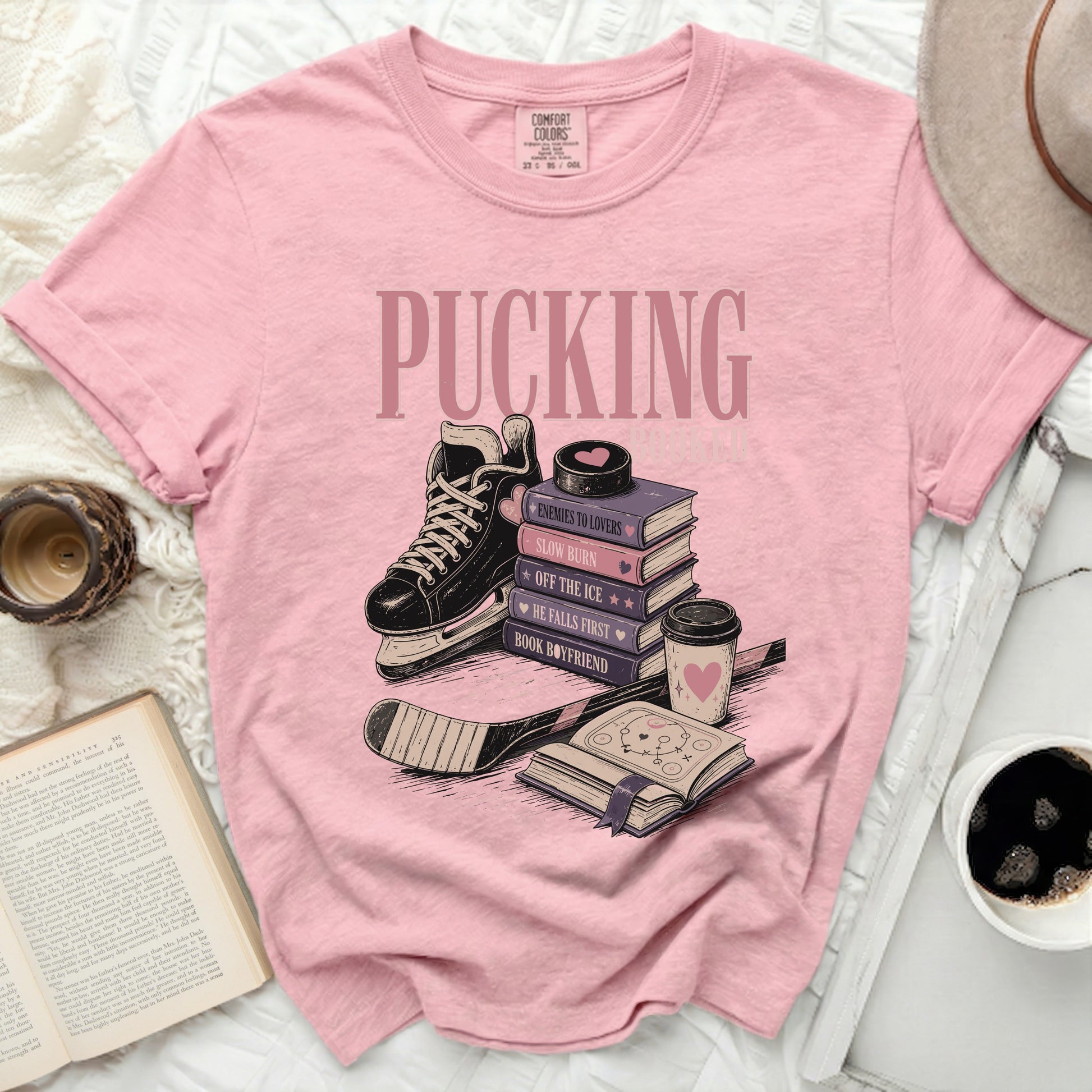 Pink t-shirt with "Pucking" and romance book titles related to hockey.