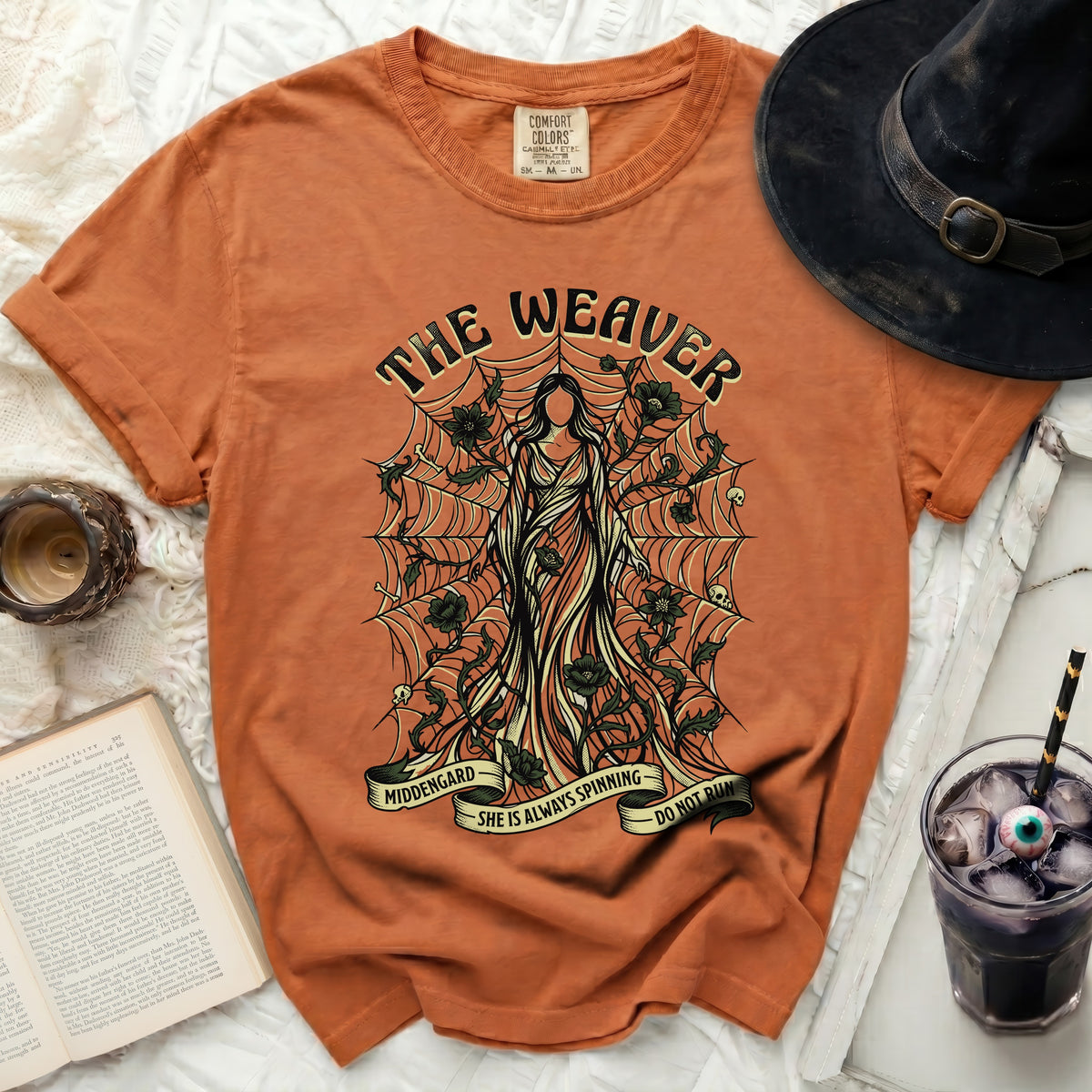 Orange t-shirt with "The Weaver" graphic and spiderweb design.
