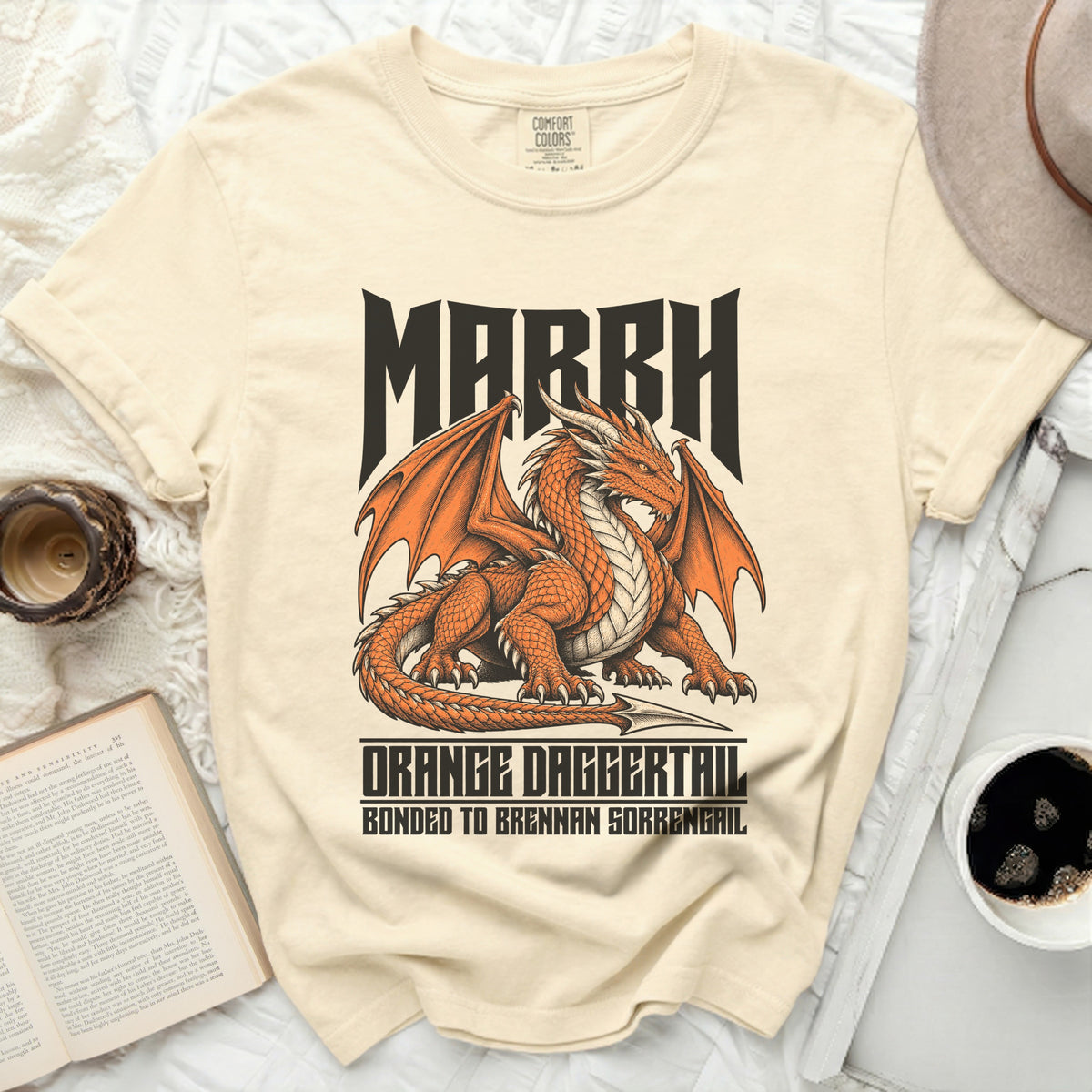 Cream t-shirt with orange dragon graphic and text "MARRH ORANGE DAGGERTAIL".