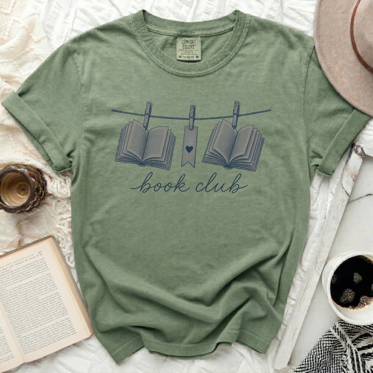 Green t-shirt with "book club" and two open books on clothesline.