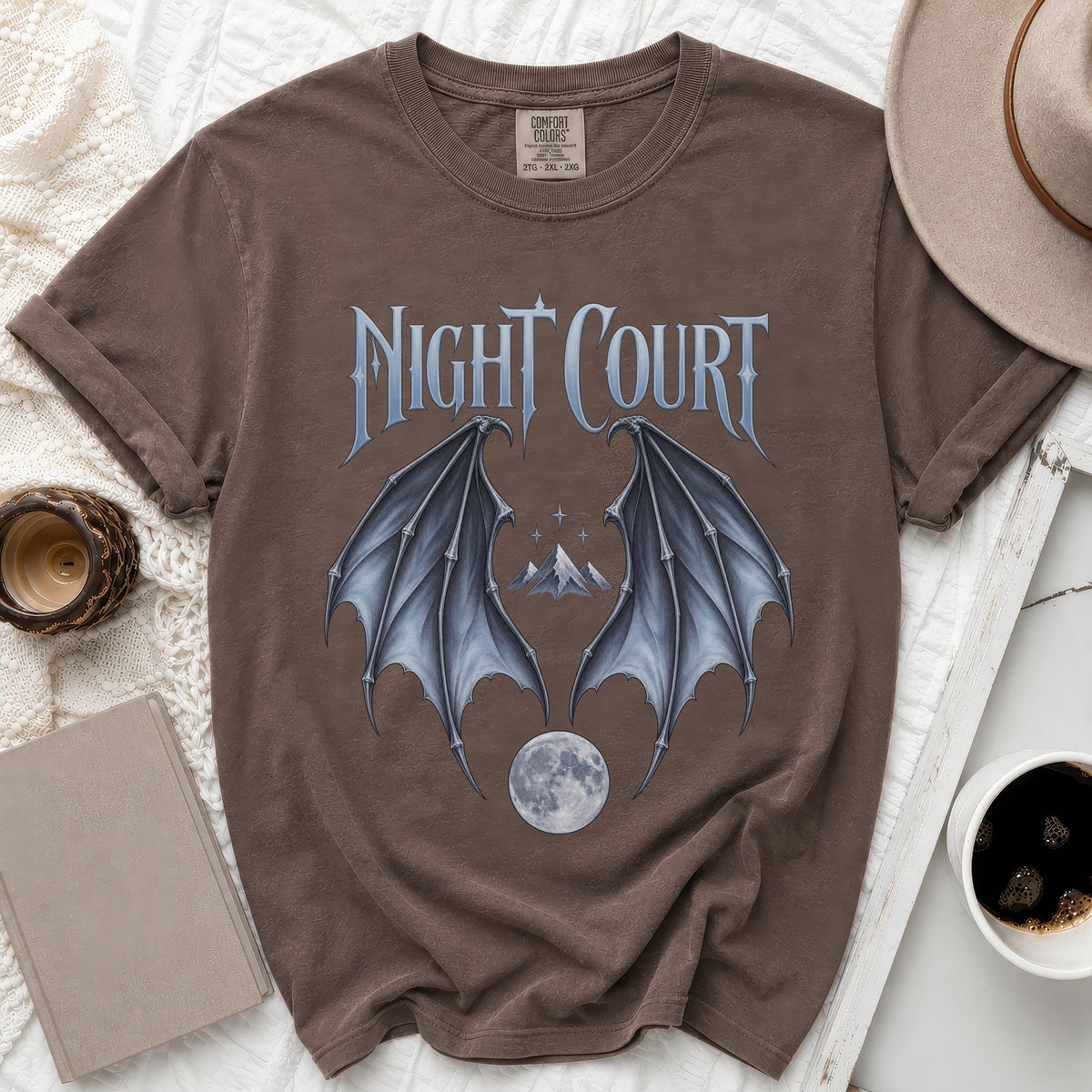 Brown t-shirt with "Night Court" text, bat wings, mountains, and moon graphic.