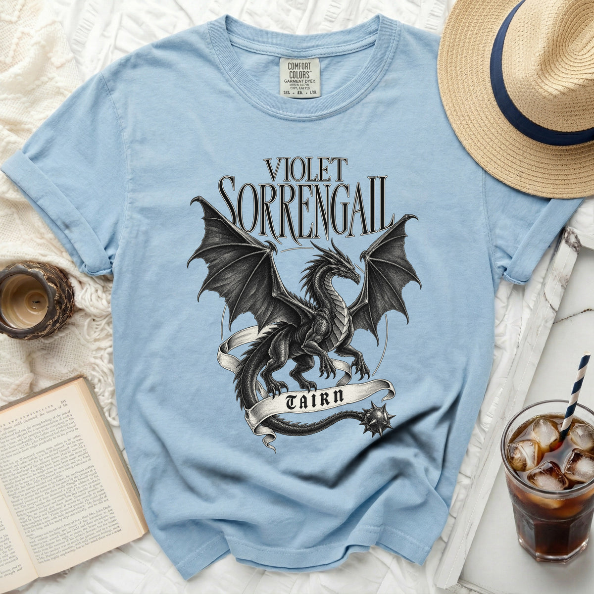 Light blue t-shirt with black dragon design and text "VIOLET SORRENGAIL TAIRN".