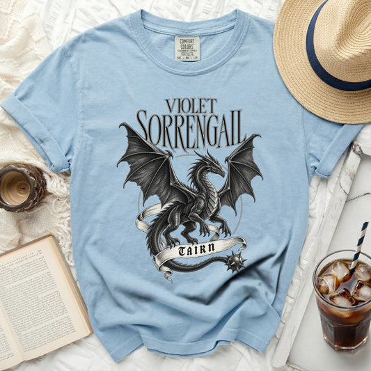 Light blue t-shirt with black dragon design and text "VIOLET SORRENGAIL TAIRN".