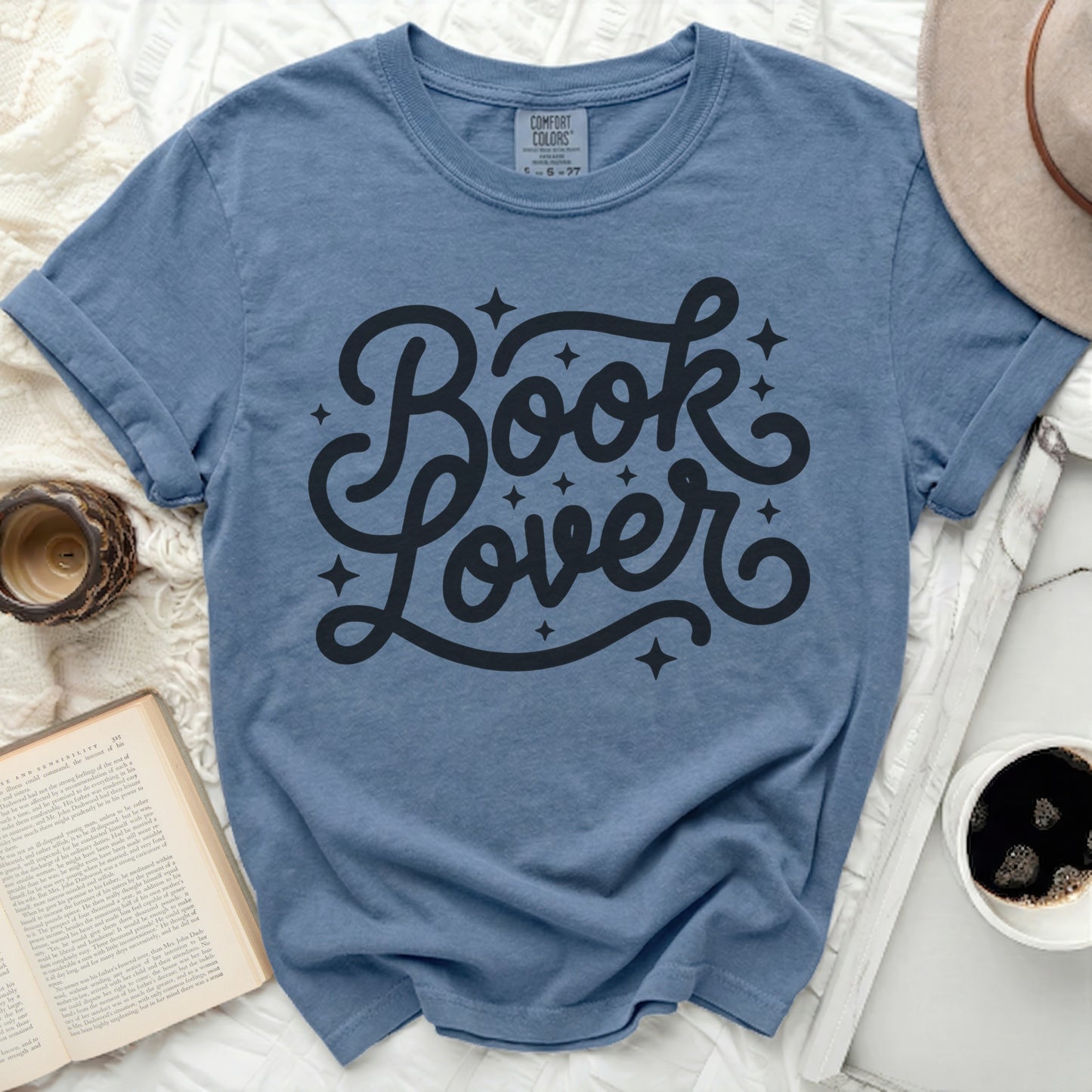 Blue t-shirt with black "Book Lover" text and small stars.