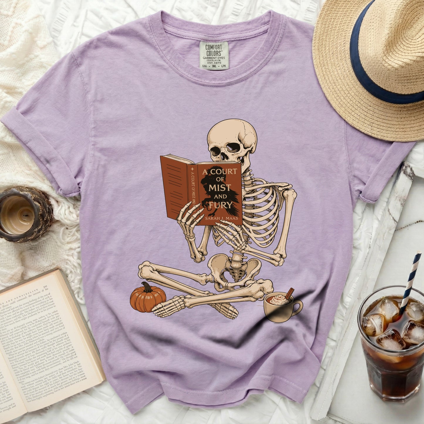 Skeleton reading "A Court of Mist and Fury" by Sarah J. Maas on lavender shirt.
