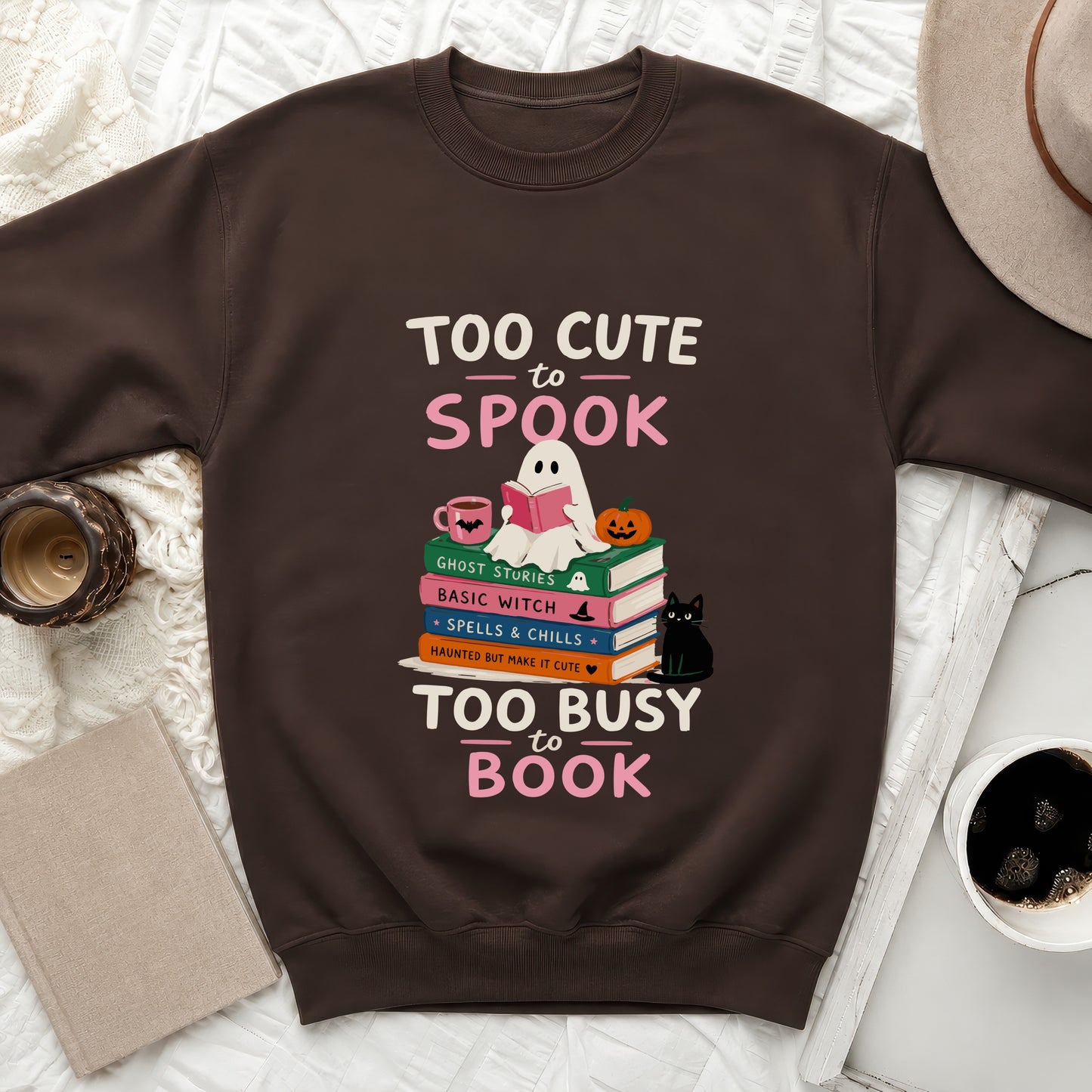 Brown sweatshirt with ghost reading books, saying "Too Cute to Spook" and "Too Busy to Book".