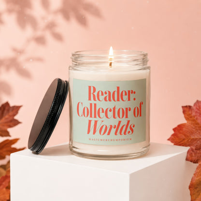 Glass candle with lit wick, featuring text "Reader: Collector of Worlds".