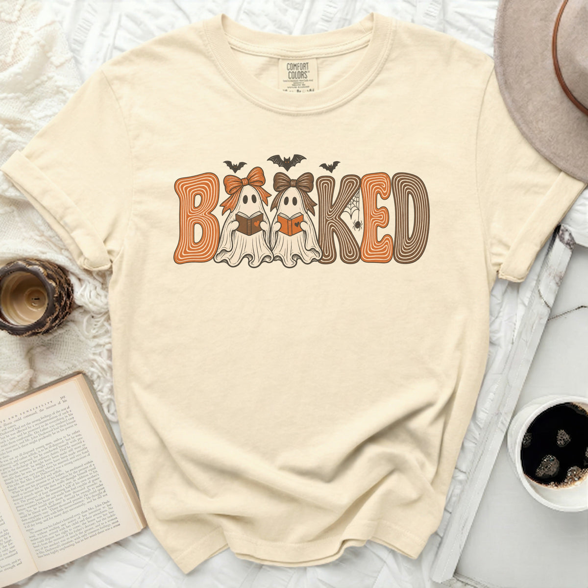 "Booked" graphic with ghosts and bats on a cream t-shirt.