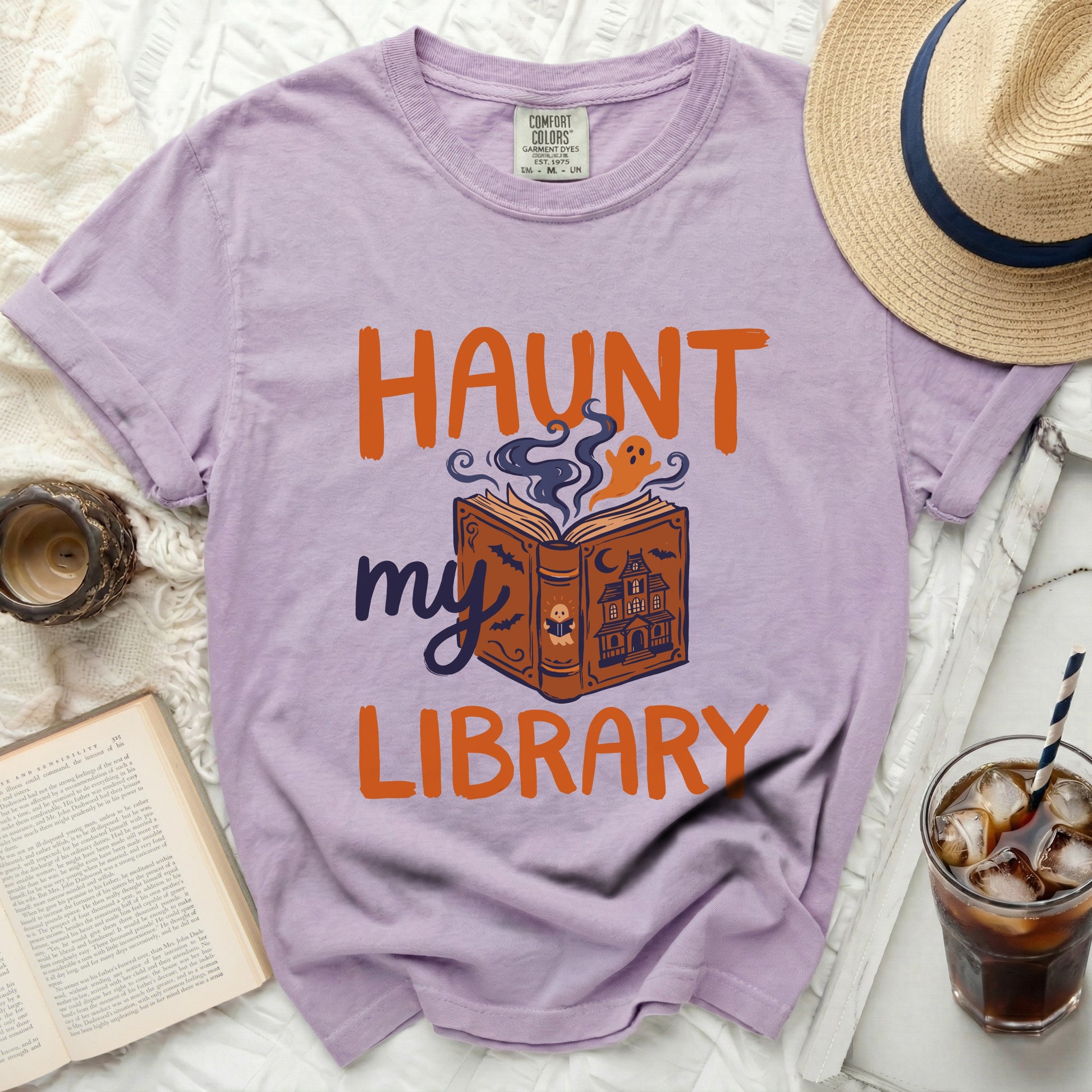 Lavender t-shirt with "Haunt my Library" Halloween graphic.