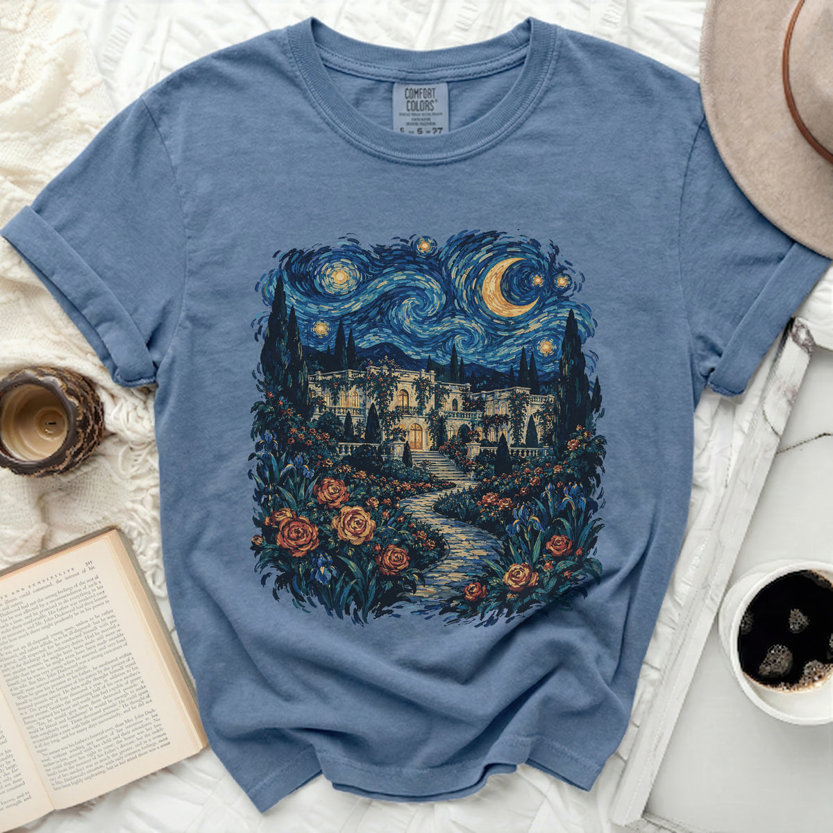 Blue t-shirt with a starry night landscape and floral garden print.