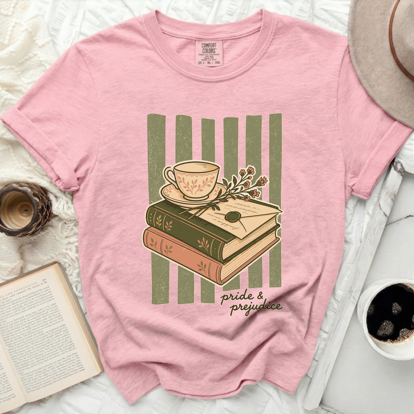 Pink t-shirt with "Pride & Prejudice" graphic of books, teacup, and letter.