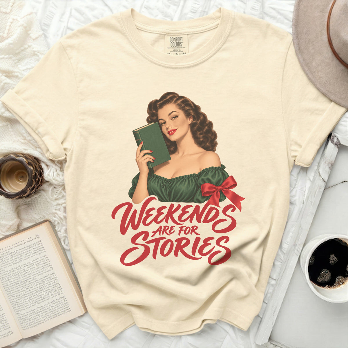 Cream t-shirt with retro pin-up girl holding book and "Weekends Are For Stories" text.