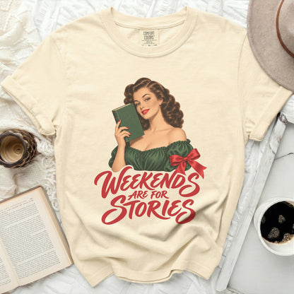 Cream t-shirt with retro pin-up girl holding book and "Weekends Are For Stories" text.