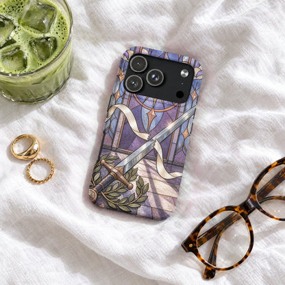 Smartphone case featuring a fantasy sword against stained glass, resting on a white fabric surface.