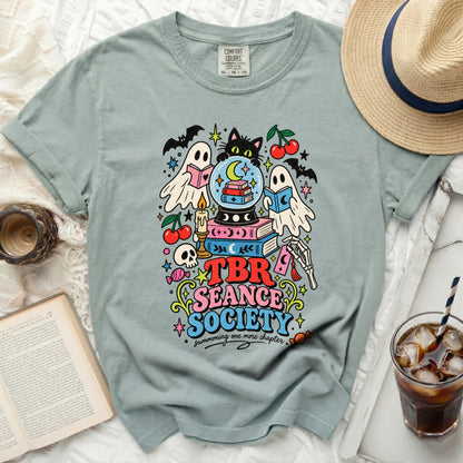 T-shirt with a "TBR Seance Society" graphic featuring ghosts, books, and a black cat.