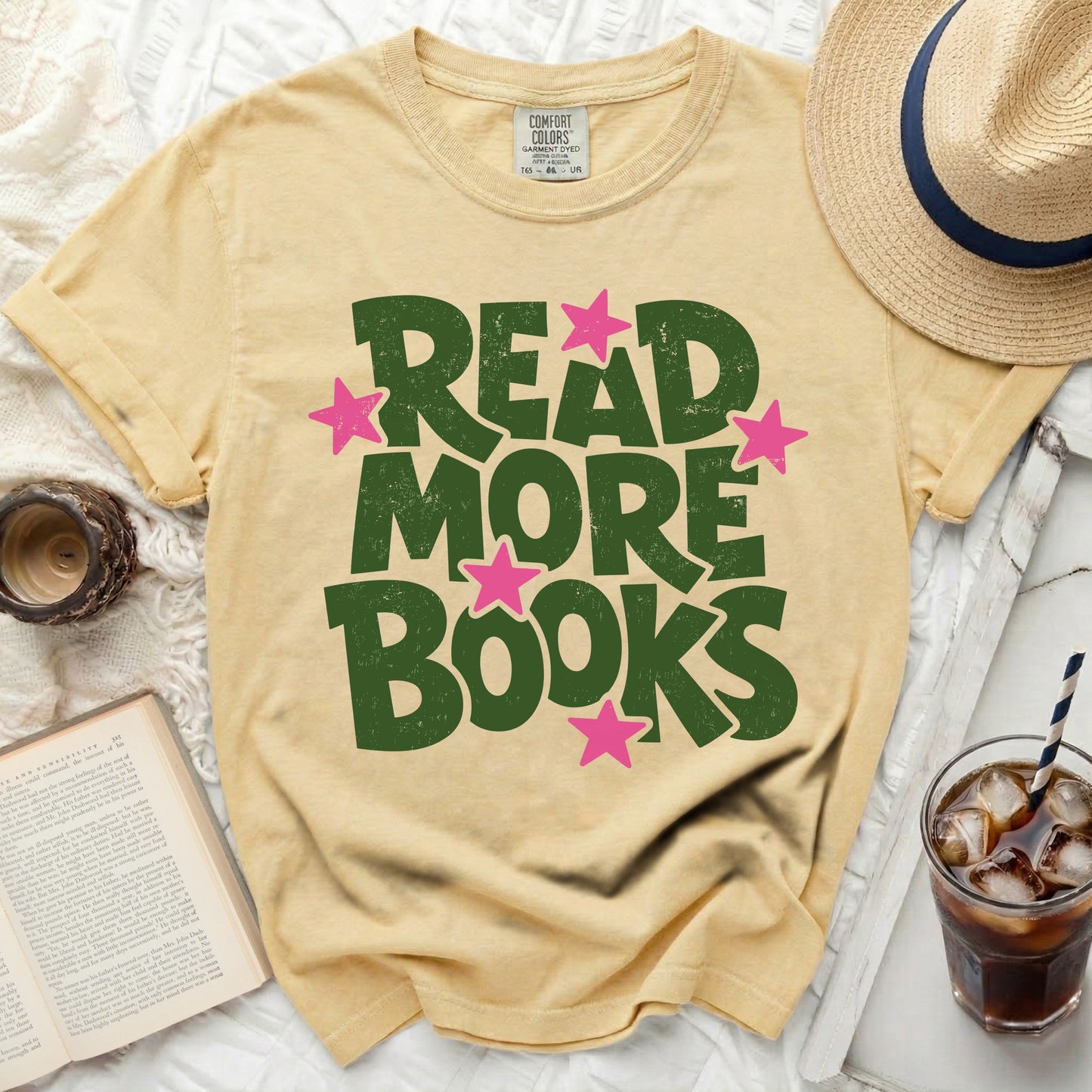 Yellow t-shirt with green "READ MORE BOOKS" text and pink stars.