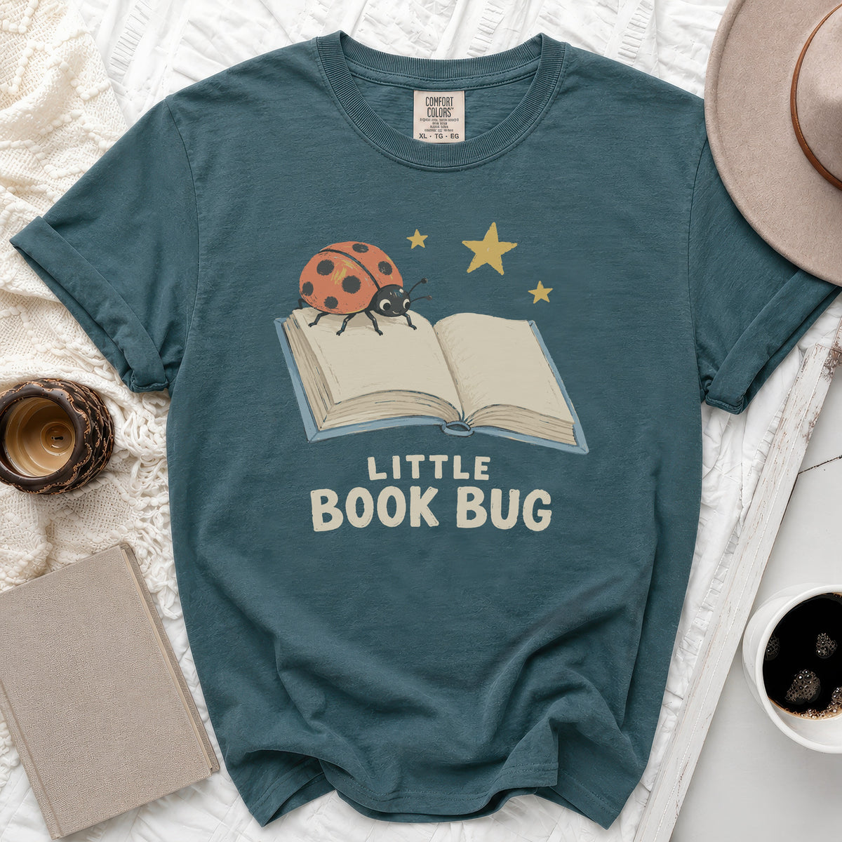 Teal t-shirt with ladybug on book graphic and text "Little Book Bug".