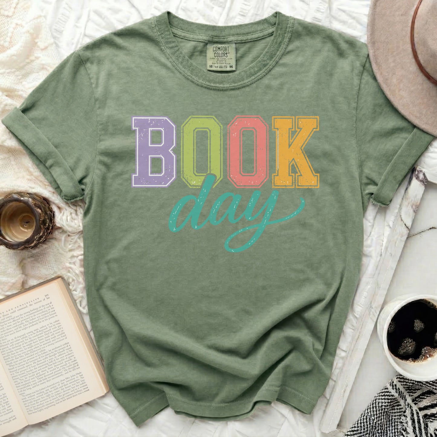 Green t-shirt with "BOOK day" text in colorful block letters.