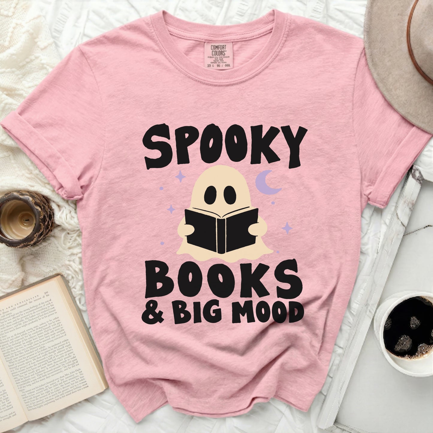 Pink t-shirt with ghost reading, "Spooky books & big mood" text.