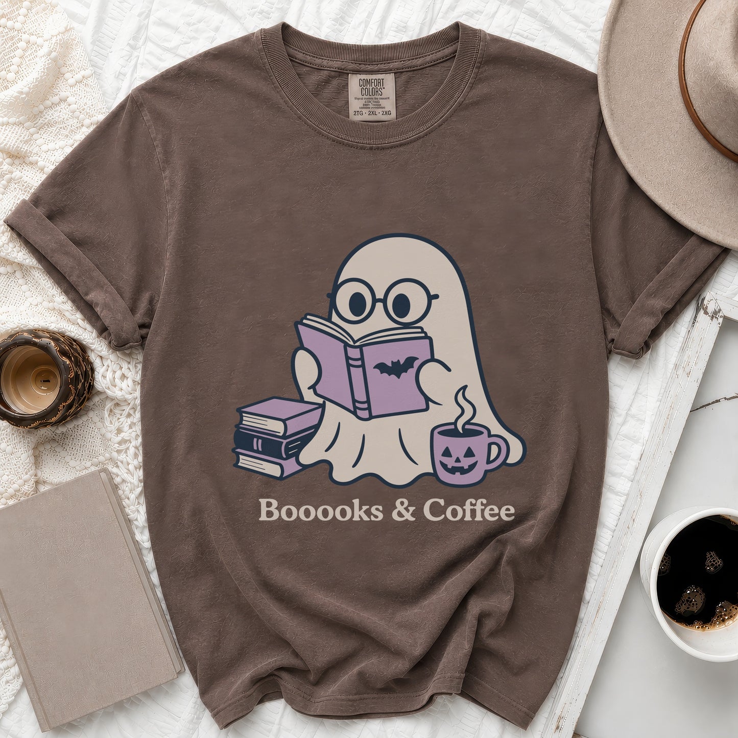 Brown t-shirt with ghost reading a book, surrounded by books and coffee.