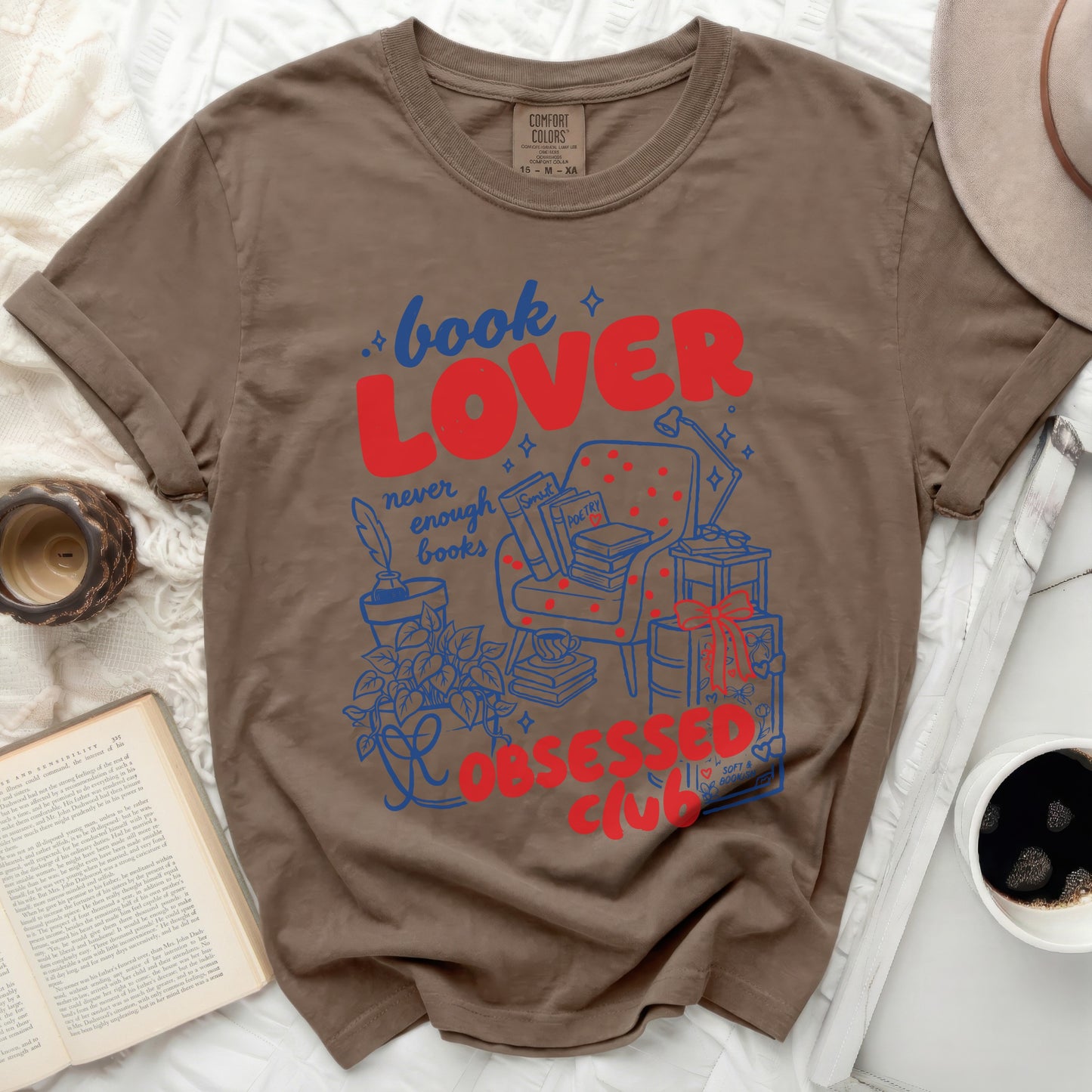 Brown t-shirt with "book LOVER never enough books obsessed club" graphic.