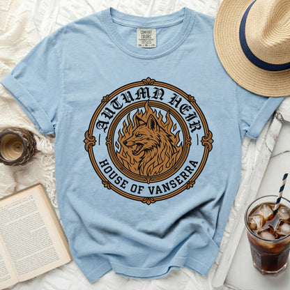 Light blue t-shirt with a circular graphic featuring a wolf in flames, "Autumn Heir" and "House of Vanserra".