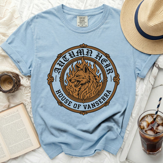 Light blue t-shirt with a circular graphic featuring a wolf in flames, "Autumn Heir" and "House of Vanserra".