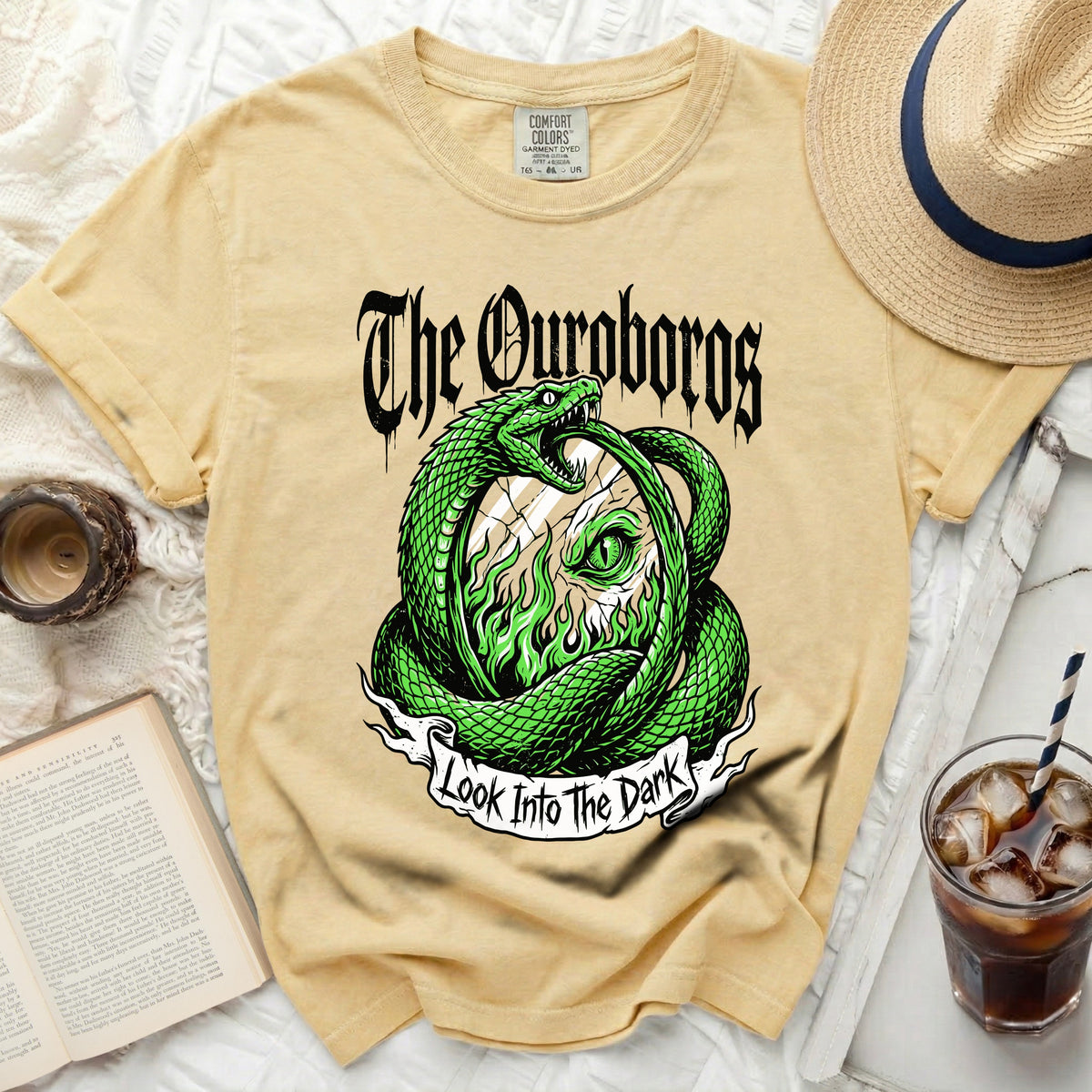 Yellow t-shirt with green Ouroboros snake design and "The Ouroboros Look Into The Dark" text.