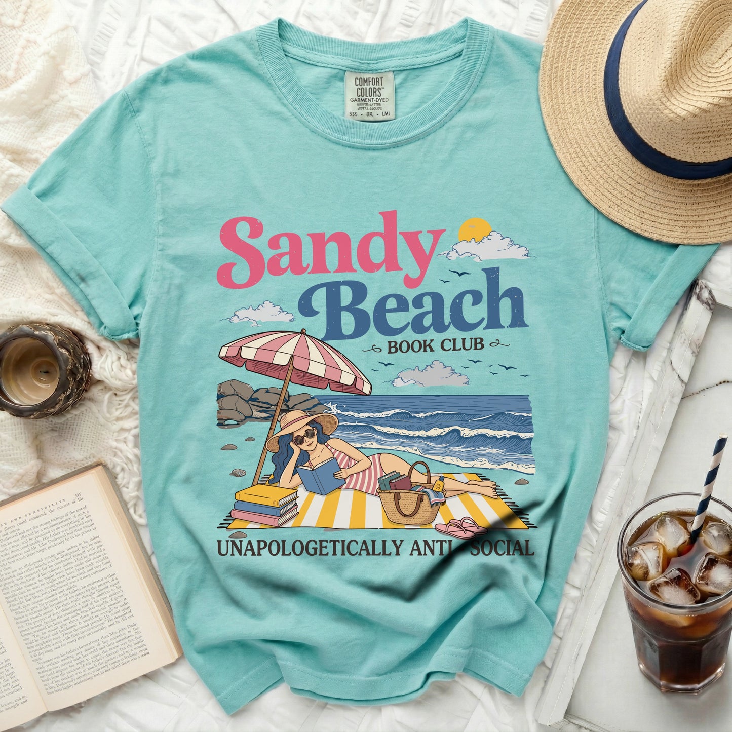 Aqua t-shirt with "Sandy Beach Book Club" and a beach reading graphic.