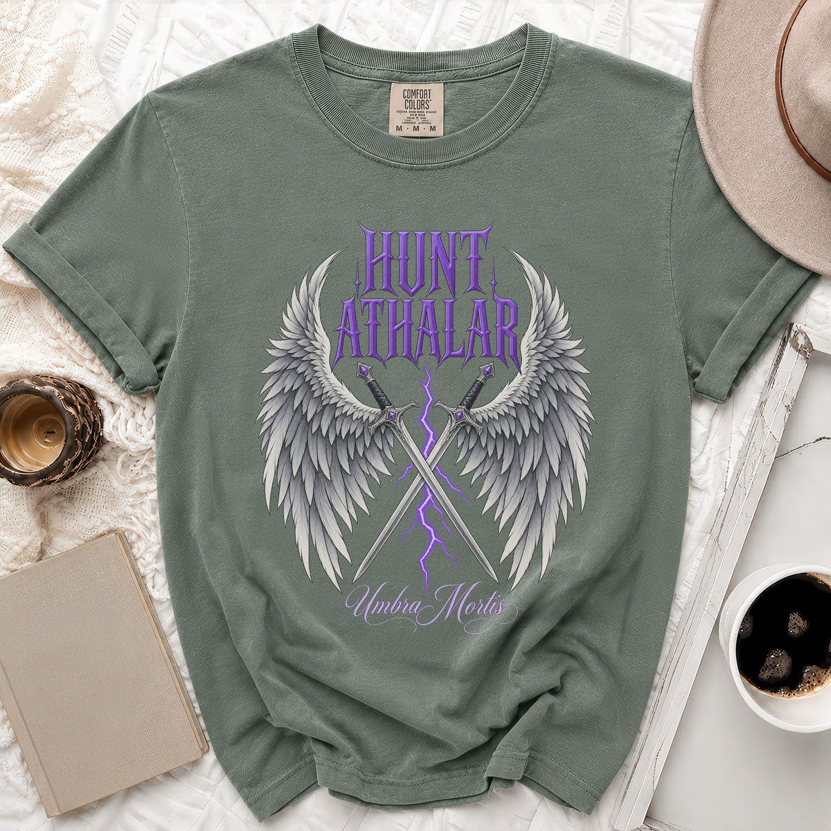Green t-shirt with purple text "HUNT ATHALAR" and winged swords.