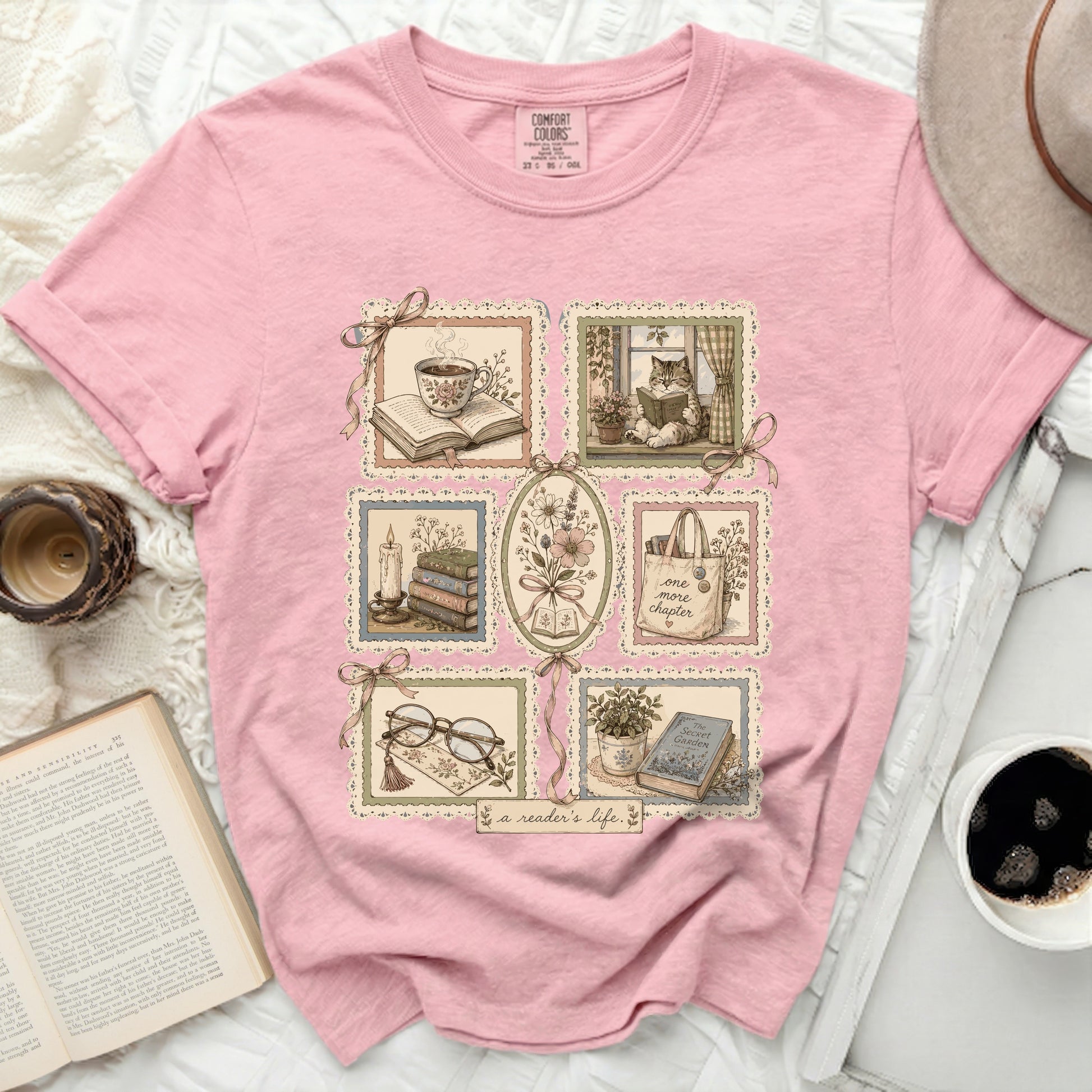 Pink t-shirt with vignettes of books, tea, and flowers and text "a reader's life."
