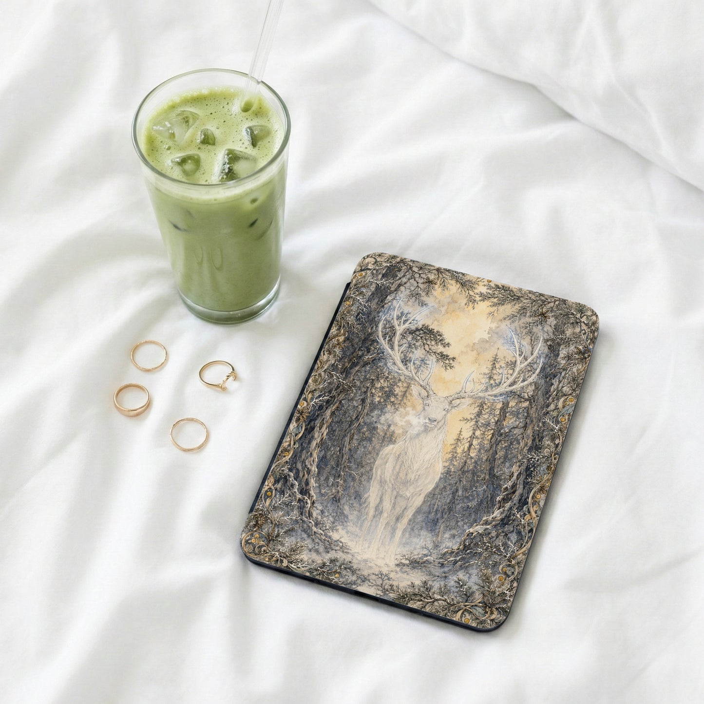 Ipad case with woodland deer illustration and a glass of iced matcha latte.
