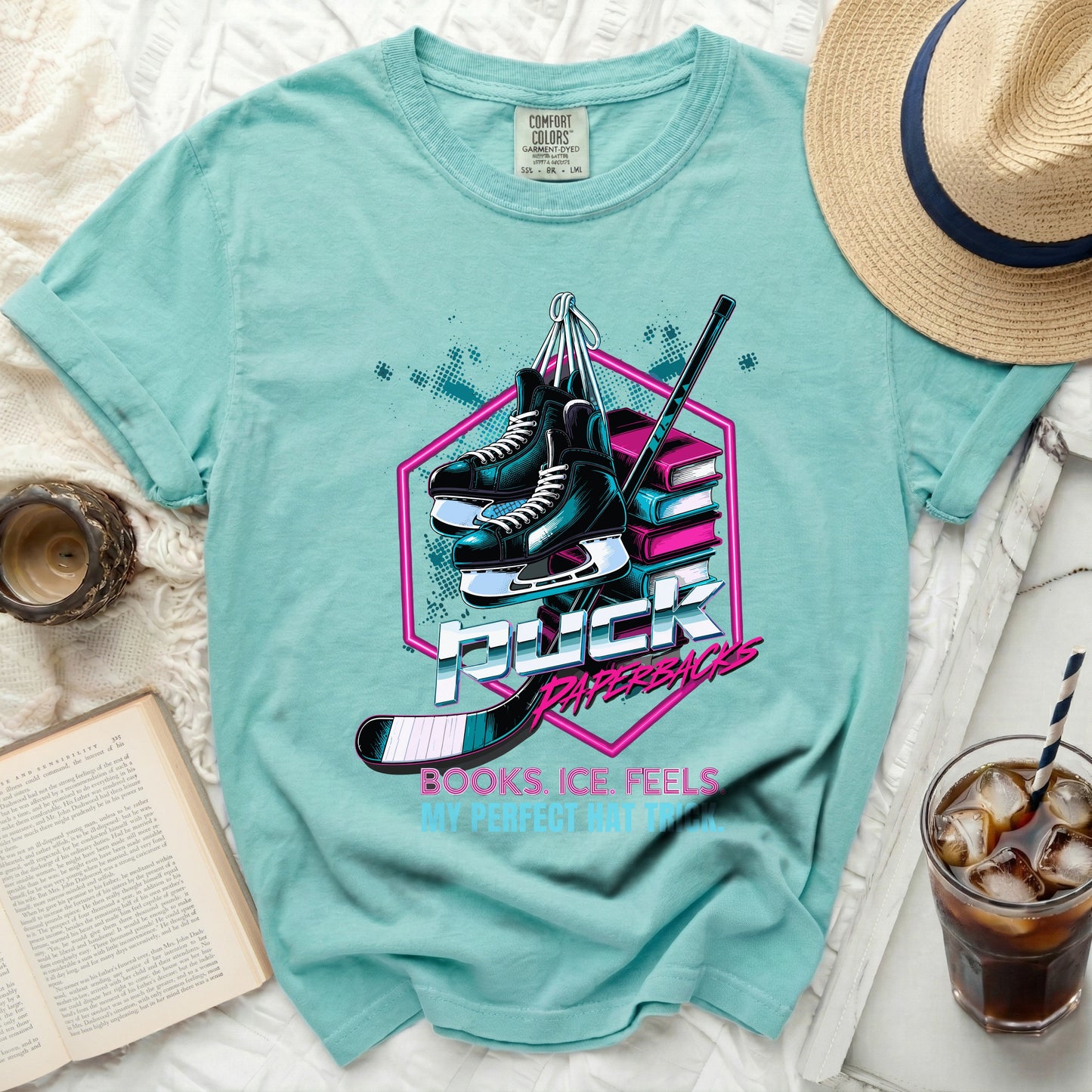 Teal t-shirt with "PUCK BOOKS ICE FEELS MY PERFECT HAT" graphic.