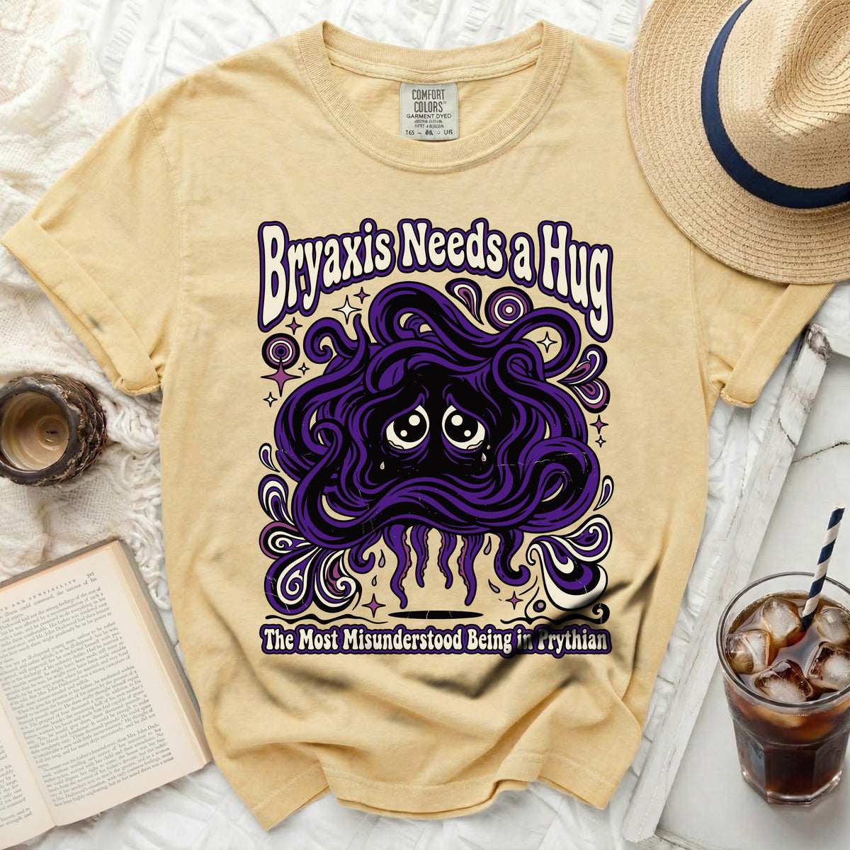 Yellow t-shirt with purple "Bryaxis Needs a Hug" and creature graphic.