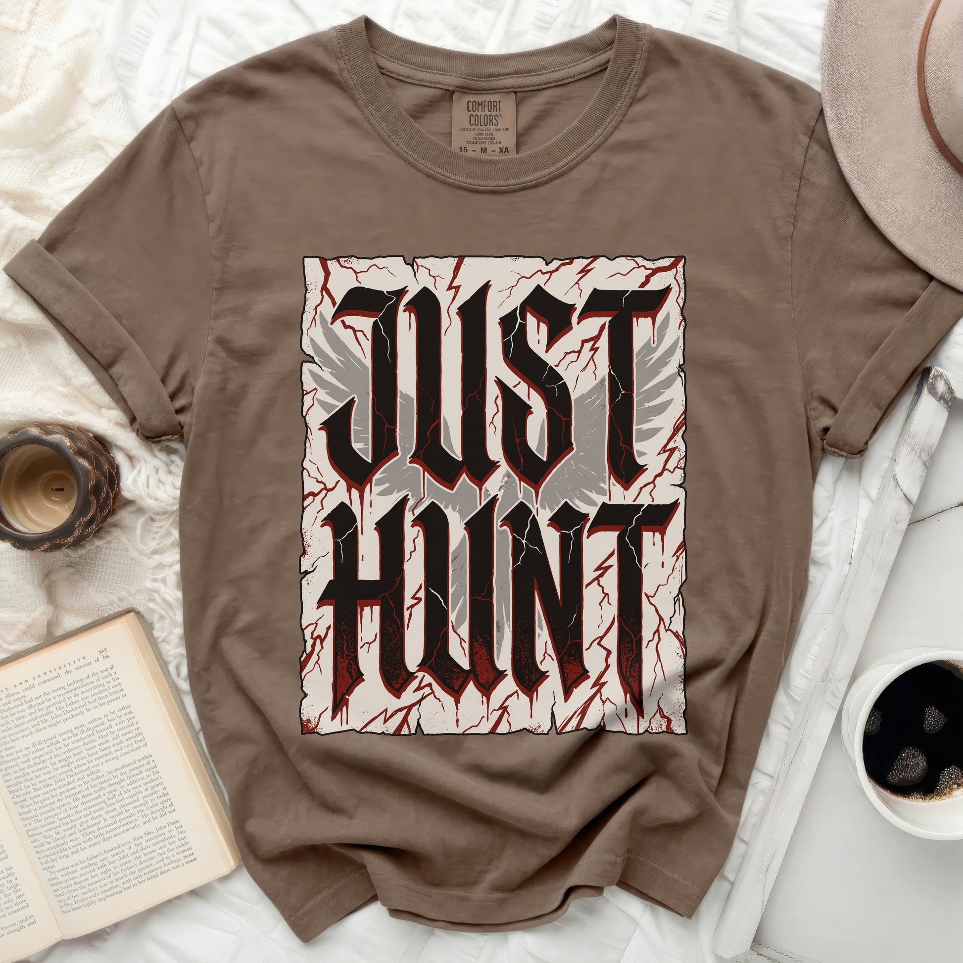 Brown t-shirt with "JUST HUNT" text in distressed gothic font and wings.