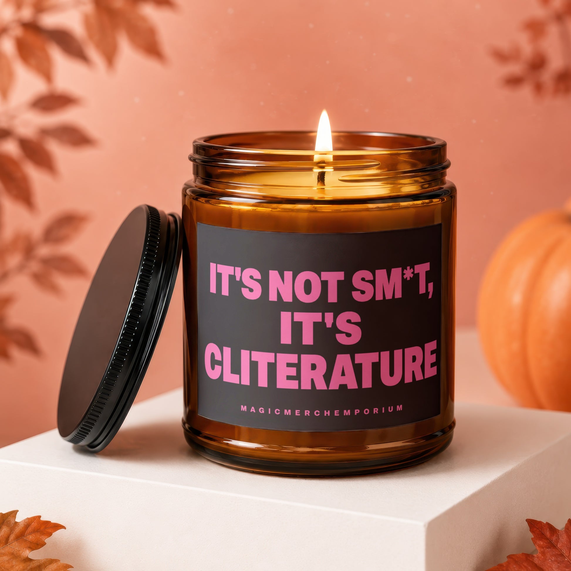 Amber jar candle with pink text "IT'S NOT SM*T, IT'S CLITERATURE" and "MAGICMERCH"