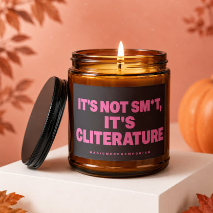 Amber jar candle with pink text "IT'S NOT SM*T, IT'S CLITERATURE" and "MAGICMERCH"