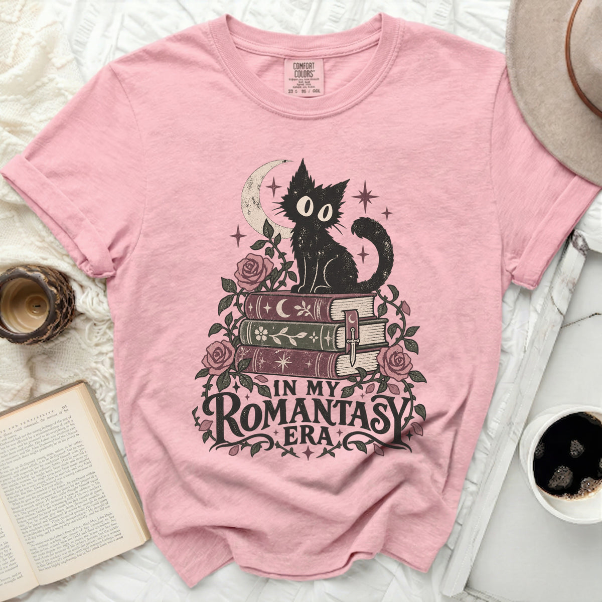 Pink t-shirt with black cat on books design and text "IN MY ROMANTASY ERA".