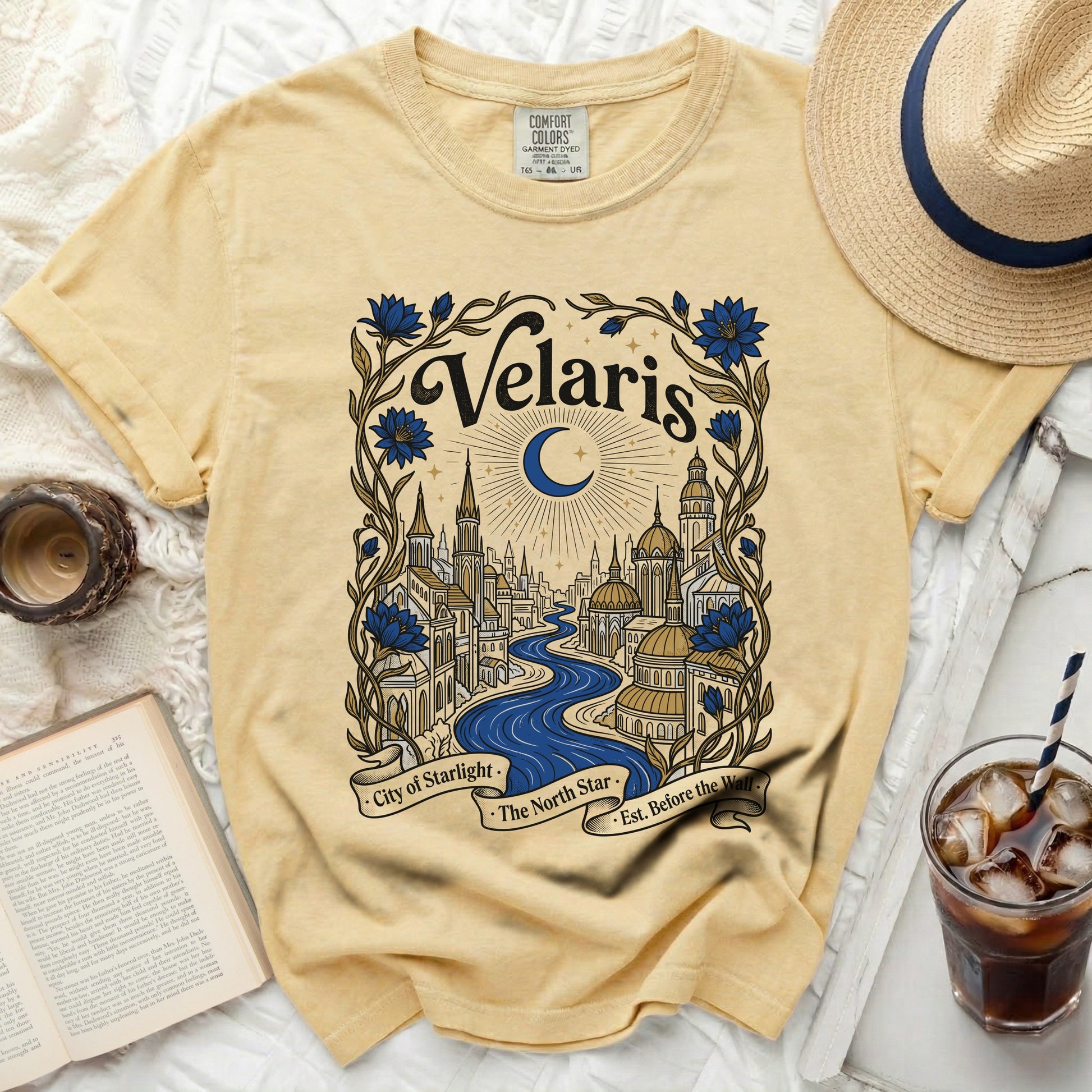Yellow t-shirt with "Velaris City of Starlight The North Star Est. Before the Wall" graphic.