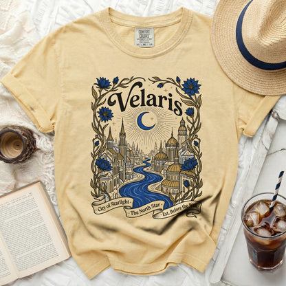 Yellow t-shirt with "Velaris City of Starlight The North Star Est. Before the Wall" graphic.