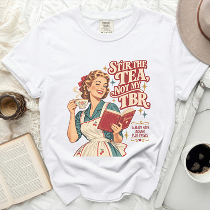White t-shirt with graphic "Stir the Tea, Not My TBR" and retro woman holding tea.
