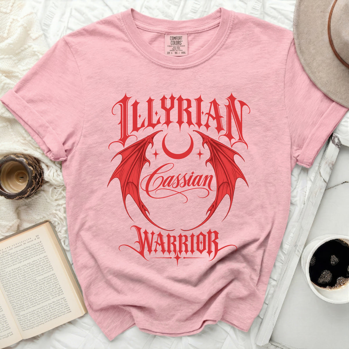 Pink t-shirt with red "ILLYRIAN Cassian WARRIOR" text and dragon wings.